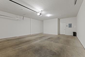 an empty room with white walls and a concrete floor